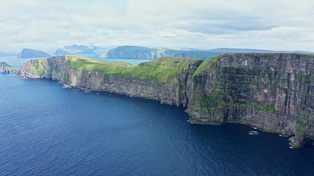 Panoramic aerial view from Sandoy island cliffs under the clouds, Faroe Islands