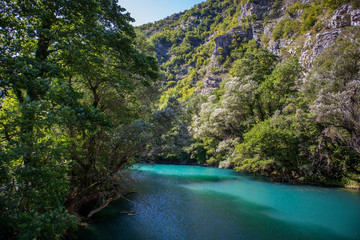 Fototapeta na wymiar Beautiful and turquoise river Una in canyon on the Croatian and Bosnia and Herzegovina border. Forest and mountains next to the river.