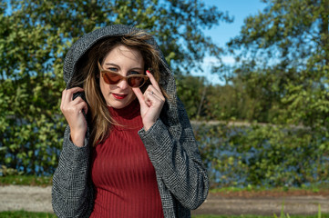 Naklejka premium A young woman enjoys a nice day in autumn.