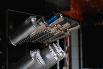 New and used motorcycle exhaust chrome pipes in a motorcykles shop or in service center.