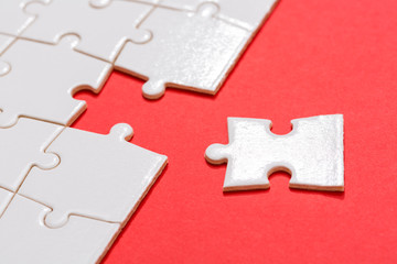 Business teamwork concept, Missing puzzle piece on red background. Search for the solution, solve the problem....