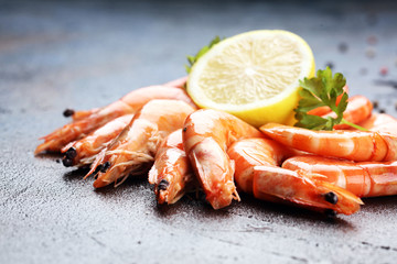 Raw fresh Prawns Langostino Austral. shrimp seafood with lemon and spices on dark