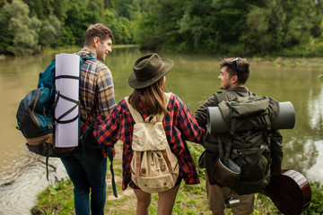 cheerful tourists having fun outdoors, close up back view photo. friendship, rest , holiday, weekend