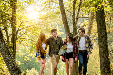 Fototapeta premium two cheerful couples having fun during adventurous travel, lifestyle, active life