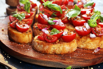 fresh tomato bruschetta. italian food appetizer with basil on table