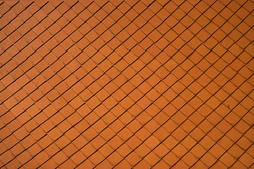 Natural orange roof tiles on a building as a texture.