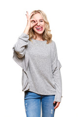 Portrait of beautiful excited woman in casual clothing smiling and showing ok sign at camera isolated over white background. Three quarter length portrait.