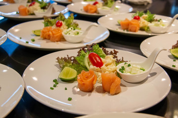 A smoke salmon salad on white plate