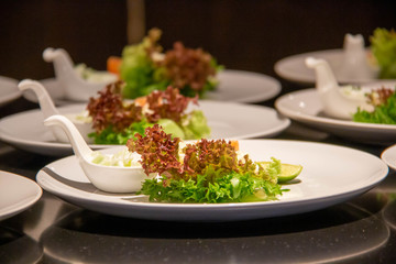 A smoke salmon salad on white plate