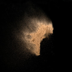 Fototapeta na wymiar Sand, isolated on black background.