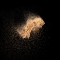 Fototapeta na wymiar Sand, isolated on black background.