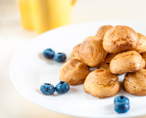 profiteroles with Blueberries on a white plate