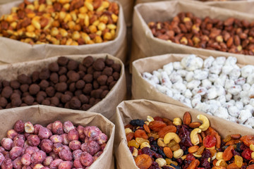 Many different nuts, dried fruits and candied fruits in paper bags. Peasant holiday fair.