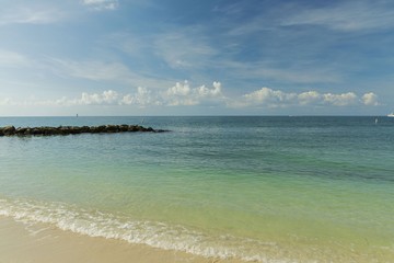 Beautiful view of Atlantic ocean sand beach. Yellow sand turning into dark blue water that merges ...