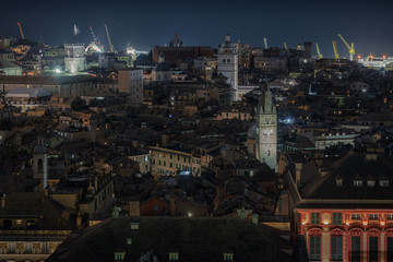 Fototapeta na wymiar Genoa, Italy. Aerial night view of the old town of medieval origin. It is the most extensive ancient historical center of Europe