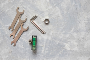 tools, wrenches, hex wrenches on concrete background, top view
