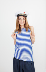 Portrait of a beautiful young girl in a sea hat and a T-shirt 