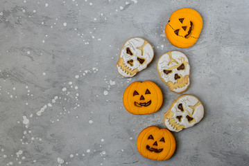 Fototapeta premium Jack O Lanterns pumpkin shaped cookies and skull shaped cookies with a glass of milk. Halloween kids breakfast.