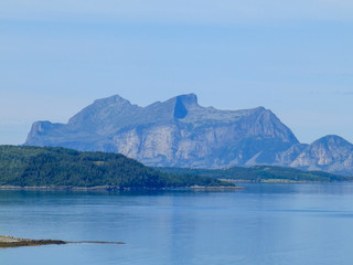 a beautiful landscape with mountains in the background and a blue fjord in the foreground