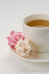 Obraz na płótnie Canvas Cup of tea with marshmallows on a white background.