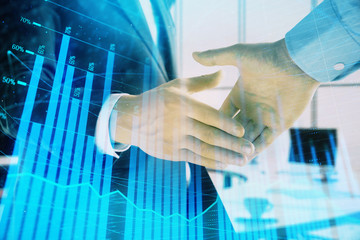 Multi exposure of financial graph on office background with two businessmen handshake. Concept of success in business