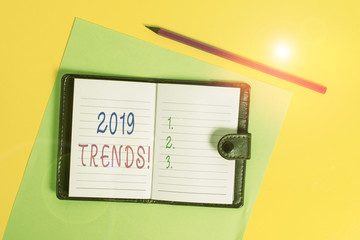 Text sign showing 2019 Trends. Business photo showcasing general direction in which something is developing or changing Dark leather private locked diary striped sheets marker colored background