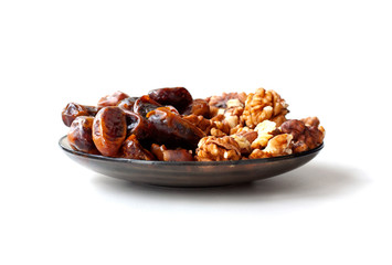 Dates with walnuts on a saucer