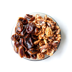 A Plate with dates and walnuts