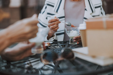 Woman and her friend enjoying dessert outdoors