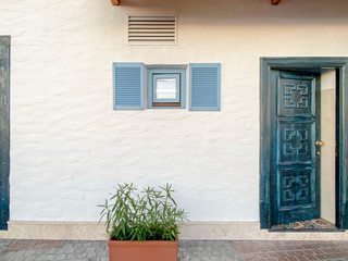 Fototapeta na wymiar blue window and blue door on a white wall
