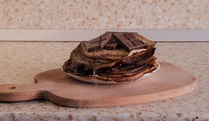 Hot pancakes on a wooden tray