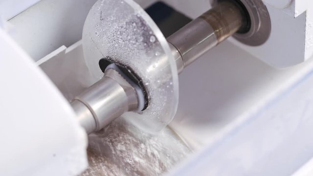 Production of lens for eyeglasses. Modern equipment of making glasses in the laboratory. Process of making new lens.