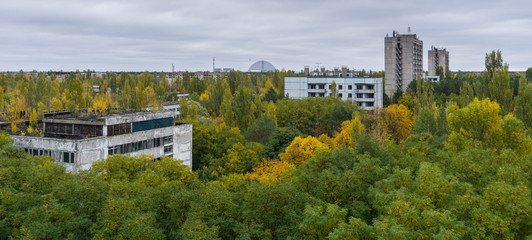 Fototapeta na wymiar View of the Chernobyl Reactor and Containment Facility from the Roof of a Nine Storey Apartment Building in the the Abandoned Amusement Park in the Evacuated City of Pripyat in the Chernobyl Exclusion