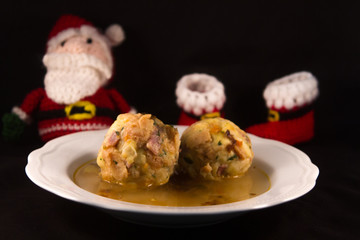 two knodels on the plate with sauerkraut and speck on the background and mug of beer and Christmas tablecloth