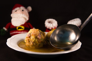 two knodels on the plate with sauerkraut and speck on the background and mug of beer and Christmas tablecloth