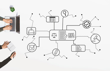 Compliance theme with people working together with laptop and notebook