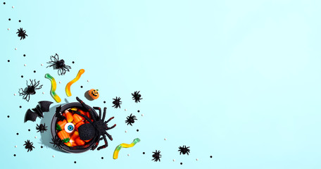 Halloween decorations with witch cauldron - overhead view flat lay