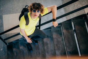 Fototapeta premium Stylish handsome teenager on steps outdoors stock photo