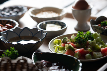 Side view of Turkish breakfast isolated on rustic wooden table