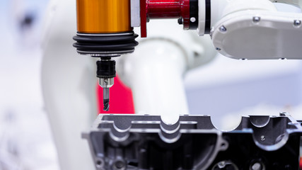 High precision CNC machining center independent axis movement  working, engineer control hand robot machining automotive sample part process in the factory