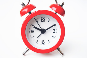 close up of a vintage red bell clock on white background