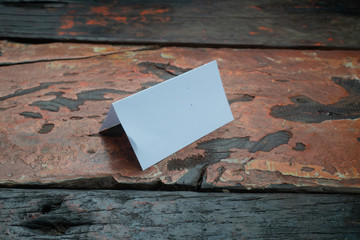 Blank paper table card isolated on rustic wooden table