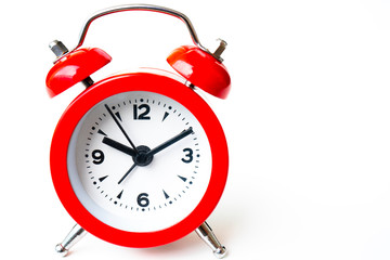 close up of a vintage red bell clock on white background