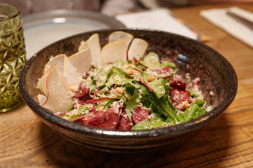 Appetizer with smoked venison, pear and green salad