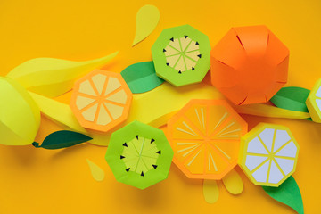 Fruit made of paper. Yellow background. Tropics.