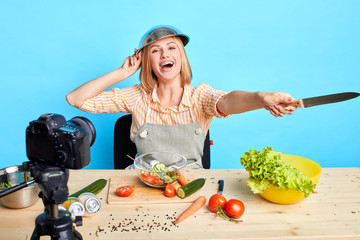 Lovely happy food vlogger girl having fun and great time, playing and pretending she is commander...