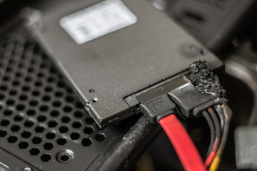 A charred, suffered a power surge burnt hard drive. suffered a power surge. black with soot. short circuit