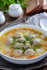 Homemade meatball and noodles soup, selective focus