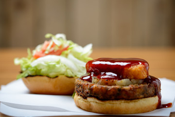 Veggie burger stack with barbecue sauce and salad