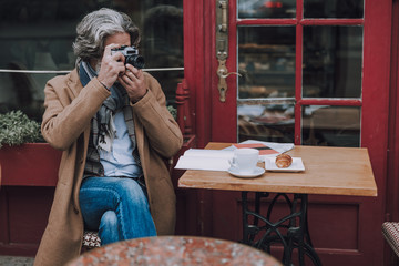 Mature photographer at the cafe table stock photo
